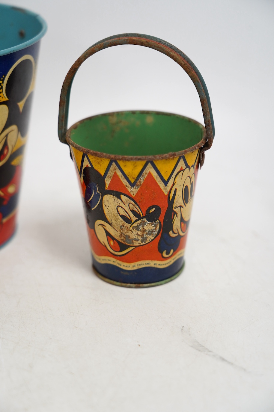 A vintage Bull Dog Bass and Guinness tinplate advertising ashtray, two Happynak Mickey Mouse toy buckets, a bakelite dog collar, etc. (5). Condition - fair